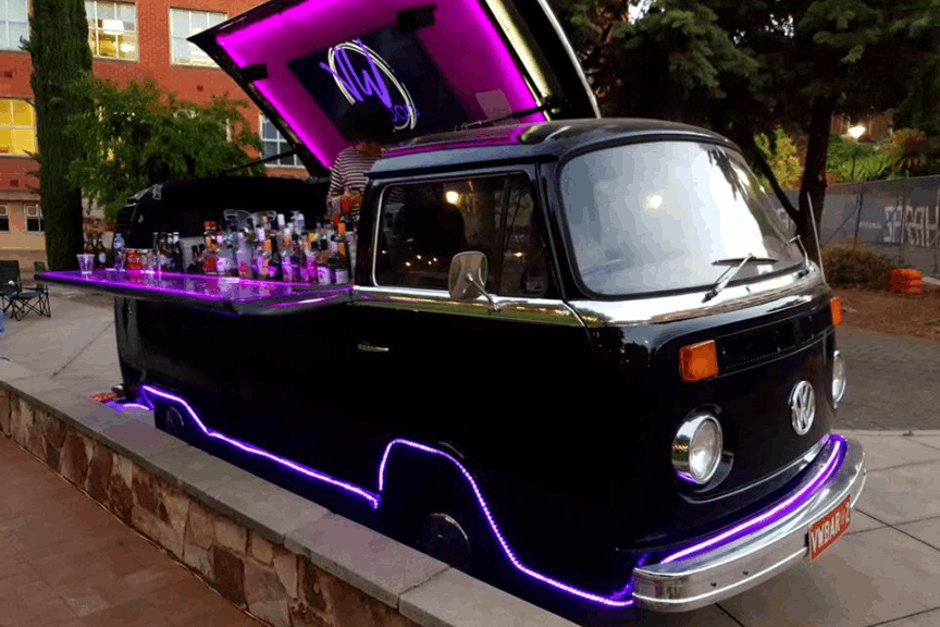 Refurbished Kombi transformed into a mobile bar by VW Bars catering an event.